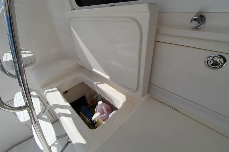  Yacht Photos Pics Storage compartment on 2005 Riviera 46 Convertible Sportfisher boat, open with cleaning supplies inside.