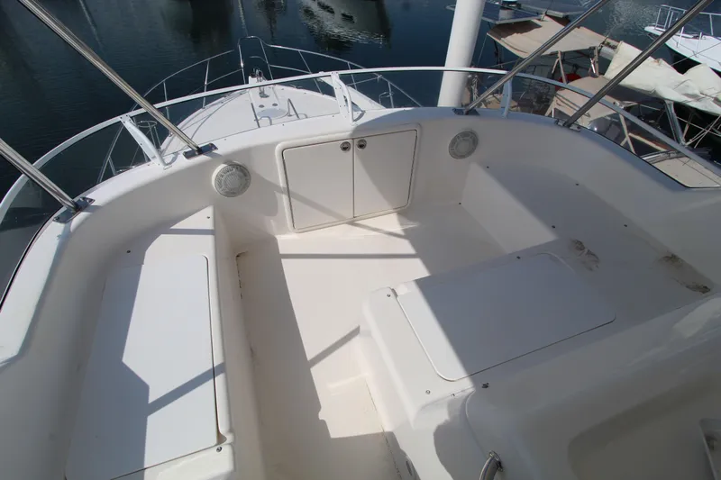  Yacht Photos Pics 2005 Riviera 46 Convertible Sportfisher boat deck with storage compartments and railing.