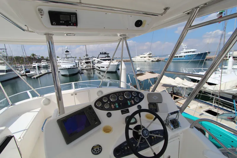  Yacht Photos Pics Helm of 2005 Riviera 46 Convertible Sportfisher overlooking marina with yachts.