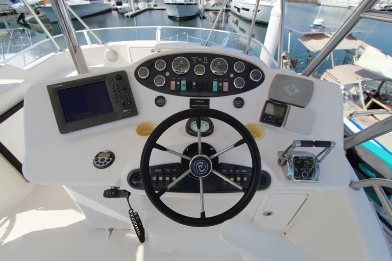  Yacht Photos Pics Control panel of 2005 Riviera 46 Convertible Sportfisher with steering wheel and navigation instruments.