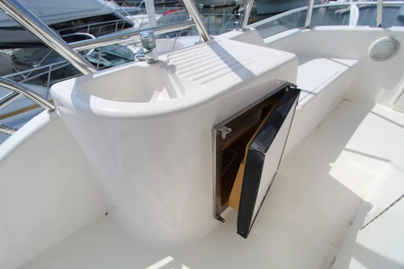  Yacht Photos Pics 2005 Riviera 46 Convertible Sportfisher with open storage compartment and sink on deck.