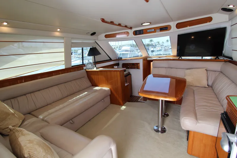  Yacht Photos Pics Luxurious interior of 2005 Riviera 46 Convertible Sportfisher yacht with plush seating and modern amenities.