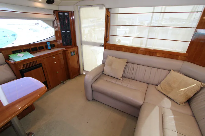  Yacht Photos Pics Luxurious interior of 2005 Riviera 46 Convertible Sportfisher with plush seating and wooden accents.