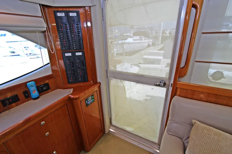  Yacht Photos Pics Interior of 2005 Riviera 46 Convertible Sportfisher, featuring control panel and wooden cabinetry.
