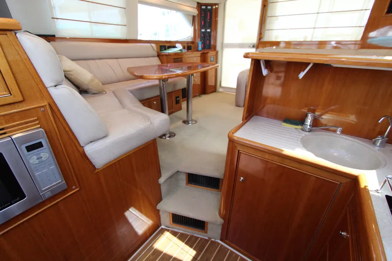 Yacht Photos Pics Luxurious interior of 2005 Riviera 46 Convertible Sportfisher with wood finishes and modern amenities.