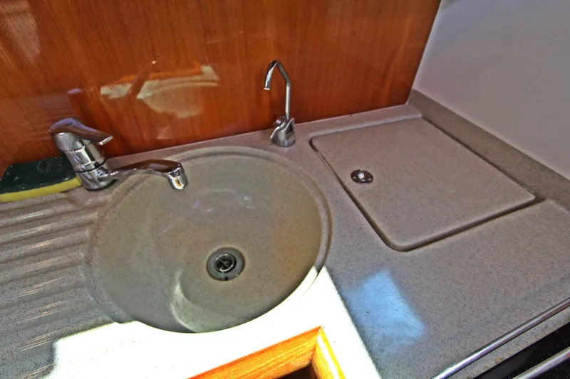  Yacht Photos Pics 2005 Riviera 46 Convertible Sportfisher kitchen sink with modern fixtures and countertop.