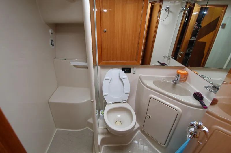  Yacht Photos Pics 2005 Riviera 46 Convertible Sportfisher bathroom with toilet, sink, and shower area.