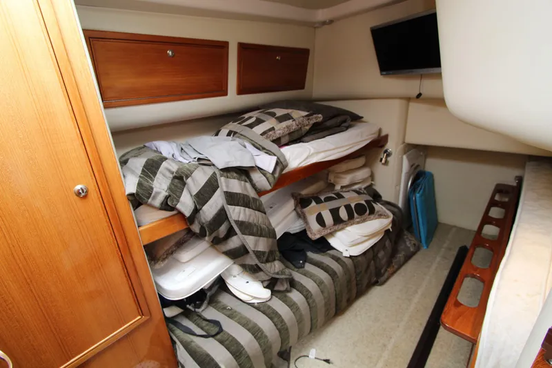  Yacht Photos Pics 2005 Riviera 46 Convertible Sportfisher cabin with bunk beds and storage cabinets.