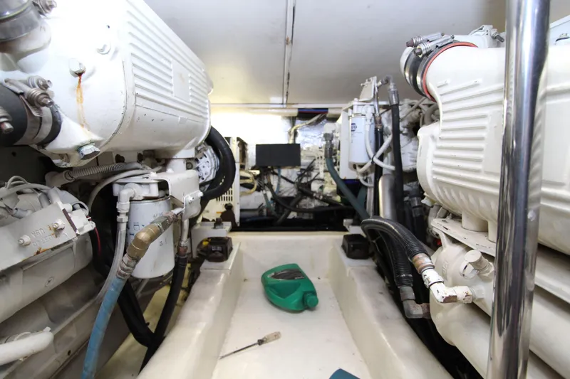  Yacht Photos Pics Engine room of 2005 Riviera 46 Convertible Sportfisher, showcasing dual engines and mechanical components.