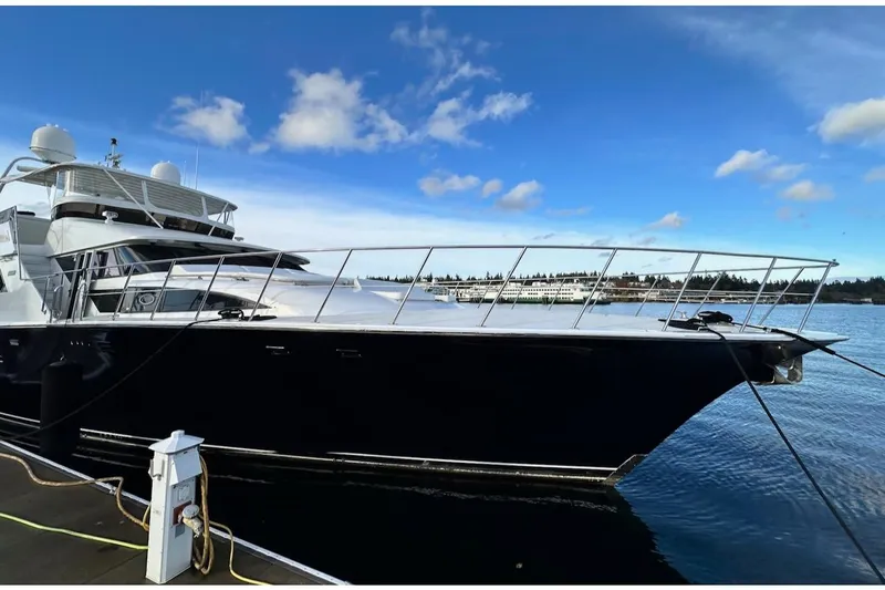 First Home Yacht Photos Pics 1988 Cheoy Lee 92 yacht docked, sleek design, clear blue sky, calm water.