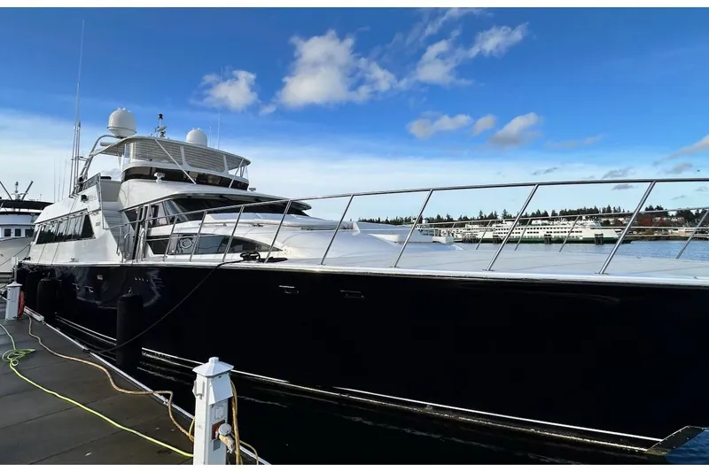First Home Yacht Photos Pics 1988 Cheoy Lee 92 yacht docked, sleek design, clear blue sky background.