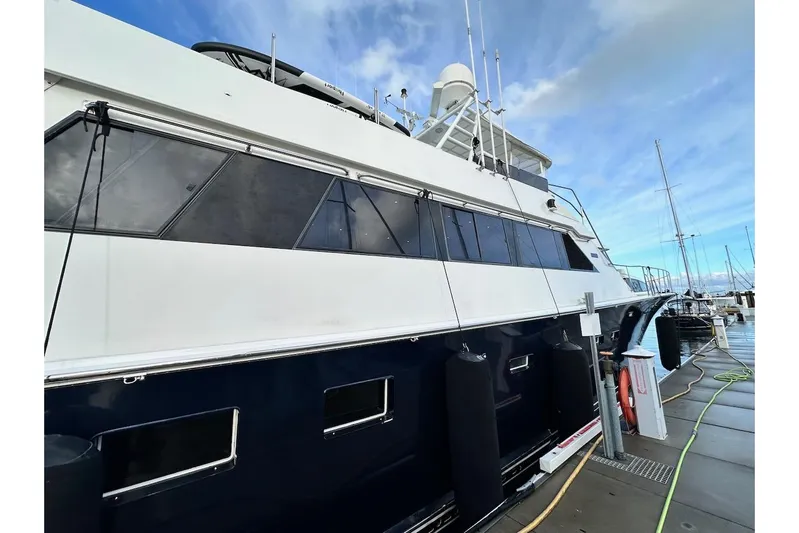 First Home Yacht Photos Pics 1988 Cheoy Lee 92 yacht docked at marina under blue sky.