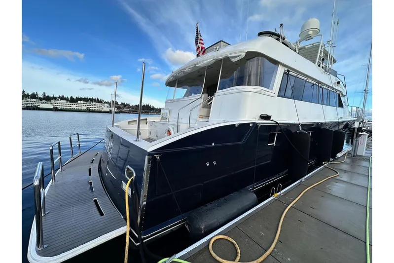 First Home Yacht Photos Pics 1988 Cheoy Lee 92 yacht docked, featuring sleek design and spacious deck.