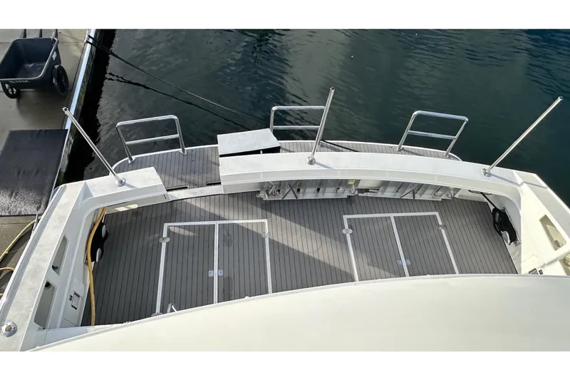 First Home Yacht Photos Pics 1988 Cheoy Lee 92 yacht deck with railing, docked by the water.