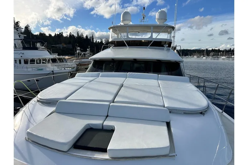 First Home Yacht Photos Pics 1988 Cheoy Lee 92 yacht with sun deck, docked in a marina under a blue sky.