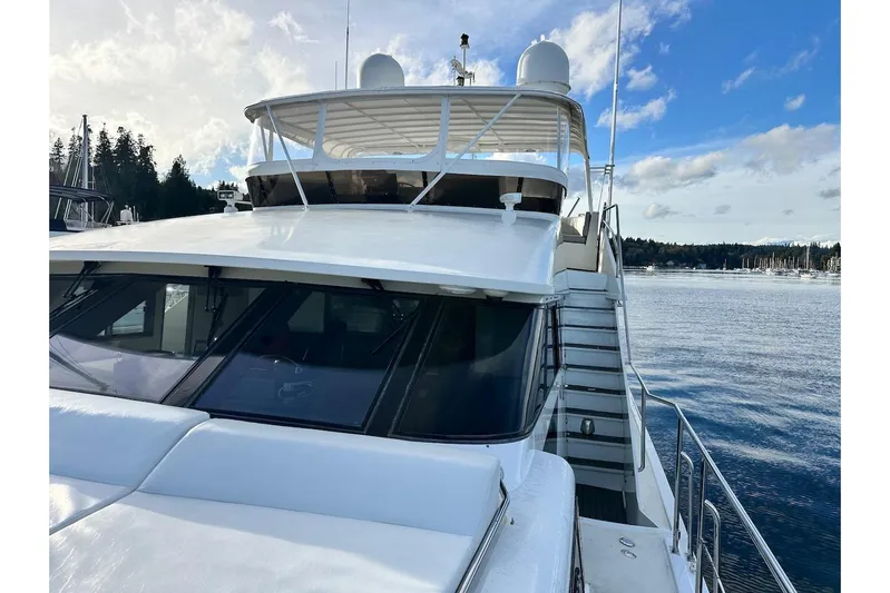First Home Yacht Photos Pics 1988 Cheoy Lee 92 yacht on serene water with clear sky background.