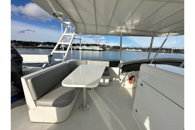 First Home Yacht Photos Pics 1988 Cheoy Lee 92 yacht deck with seating area and scenic waterfront view.