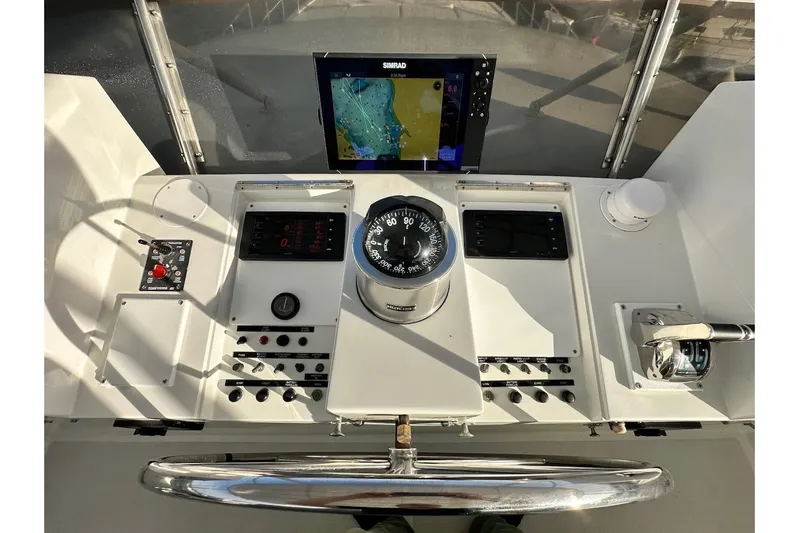 First Home Yacht Photos Pics Helm of 1988 Cheoy Lee 92 yacht with navigation equipment and compass.