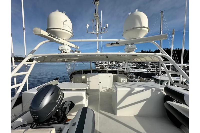 First Home Yacht Photos Pics 1988 Cheoy Lee 92 yacht deck with Simrad radar and Yamaha motor, docked in marina.