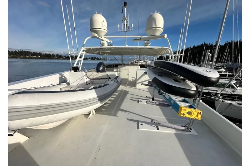 First Home Yacht Photos Pics 1988 Cheoy Lee 92 yacht deck with inflatable boat and paddleboards.