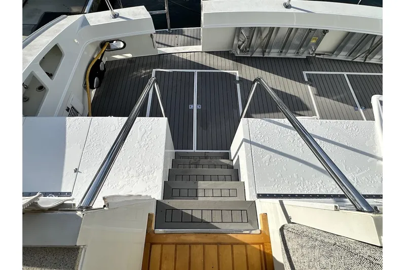 First Home Yacht Photos Pics Staircase on 1988 Cheoy Lee 92 yacht with sleek deck design.