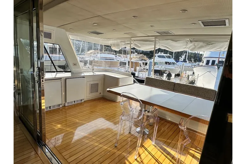 First Home Yacht Photos Pics Luxurious 1988 Cheoy Lee 92 yacht interior with elegant seating and marina view.