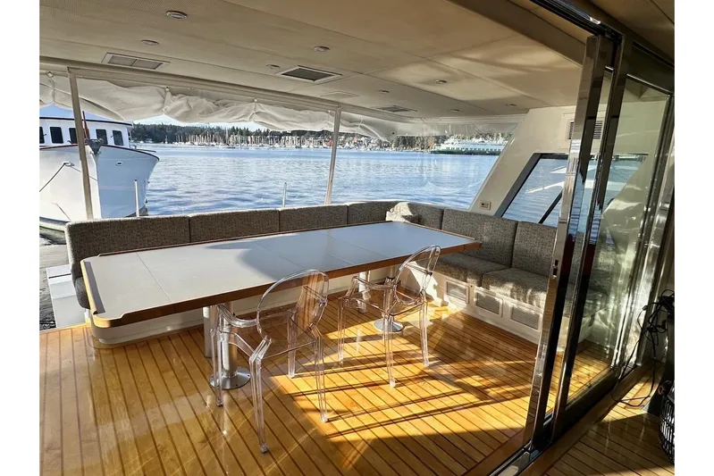 First Home Yacht Photos Pics Luxurious 1988 Cheoy Lee 92 yacht interior with elegant dining area and scenic water view.