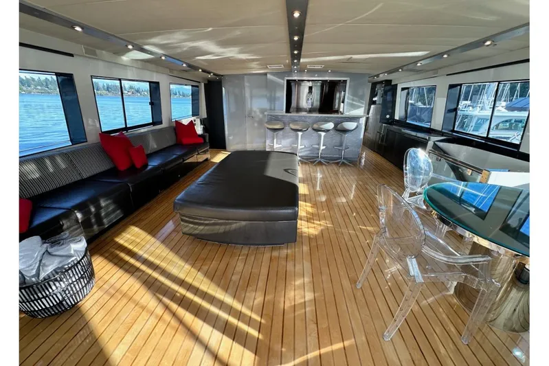 First Home Yacht Photos Pics Luxurious interior of 1988 Cheoy Lee 92 yacht with modern seating and panoramic windows.