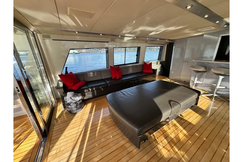 First Home Yacht Photos Pics Luxurious interior of 1988 Cheoy Lee 92 yacht with modern seating and scenic water views.