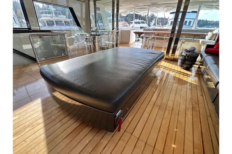 First Home Yacht Photos Pics Luxurious interior of 1988 Cheoy Lee 92 yacht with sleek furnishings and polished wood flooring.