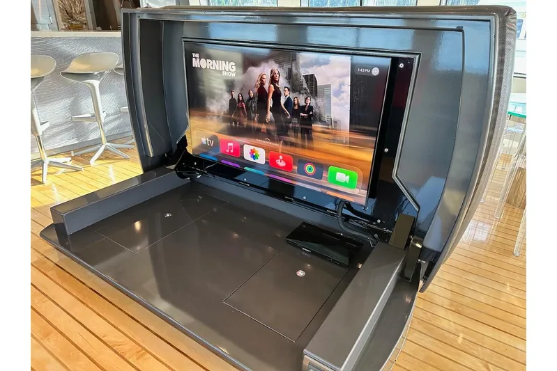 First Home Yacht Photos Pics Luxury yacht interior with pop-up TV, Cheoy Lee 92, 1988 model, modern entertainment setup.