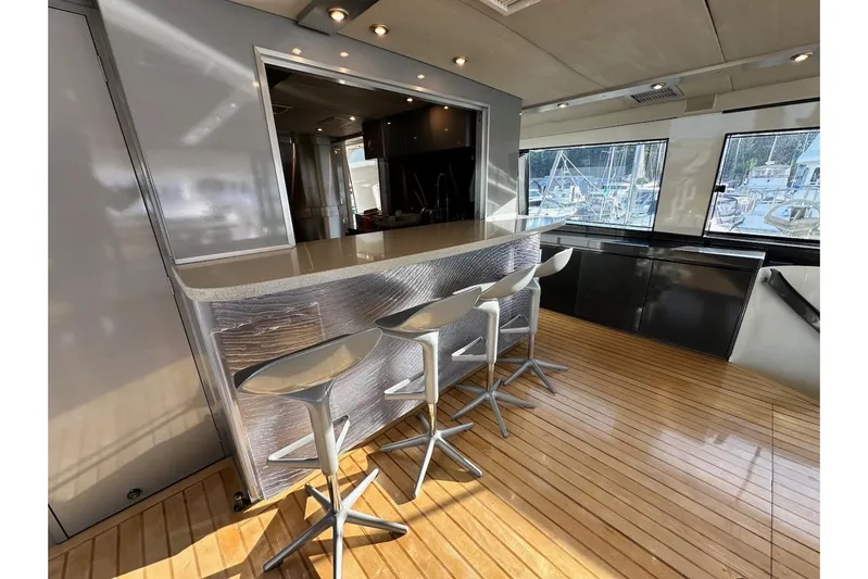 First Home Yacht Photos Pics Luxurious interior of 1988 Cheoy Lee 92 yacht with modern bar and seating.