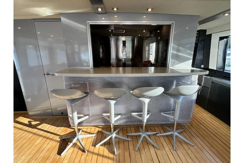 First Home Yacht Photos Pics Modern bar area with sleek stools on a 1988 Cheoy Lee 92 yacht.