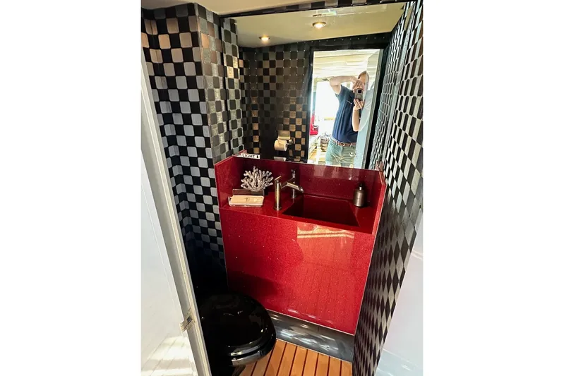 First Home Yacht Photos Pics Luxurious bathroom on 1988 Cheoy Lee 92 yacht with red sink and checkered walls.