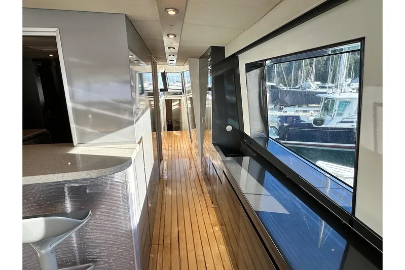 First Home Yacht Photos Pics Luxurious interior of 1988 Cheoy Lee 92 yacht with sleek design and large windows.