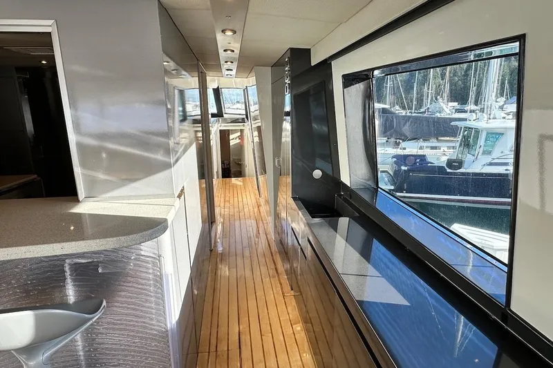 First Home Yacht Photos Pics Interior view of 1988 Cheoy Lee 92 yacht with sleek design and large windows.