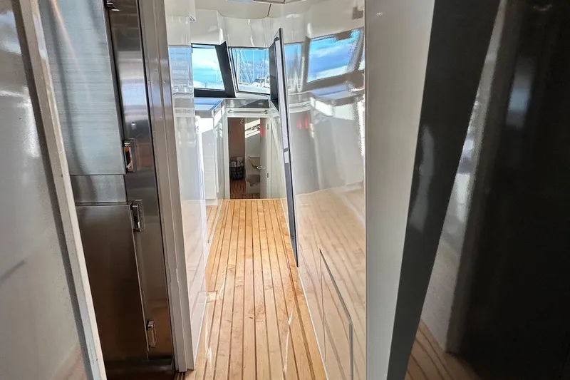 First Home Yacht Photos Pics Interior hallway of 1988 Cheoy Lee 92 yacht with wooden flooring and modern design.