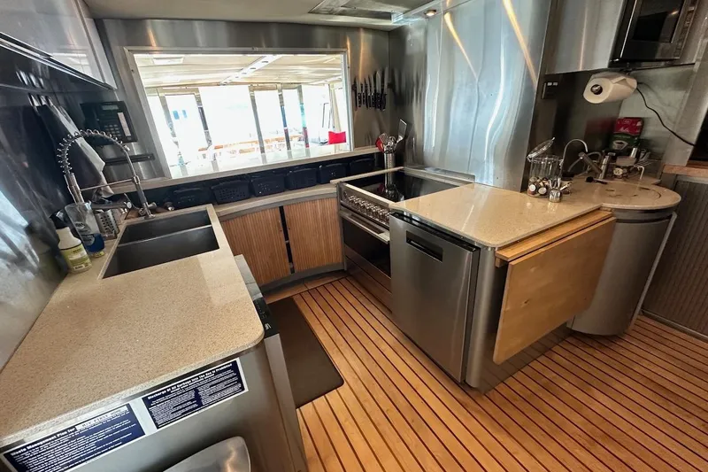 First Home Yacht Photos Pics Modern kitchen interior on 1988 Cheoy Lee 92 yacht with stainless steel appliances.