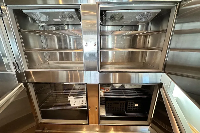 First Home Yacht Photos Pics Stainless steel refrigerator interior on a 1988 Cheoy Lee 92 yacht.