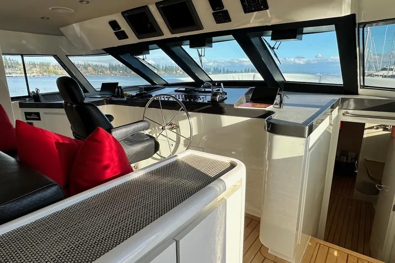 First Home Yacht Photos Pics Luxurious 1988 Cheoy Lee 92 yacht interior with helm, leather seating, and panoramic windows.