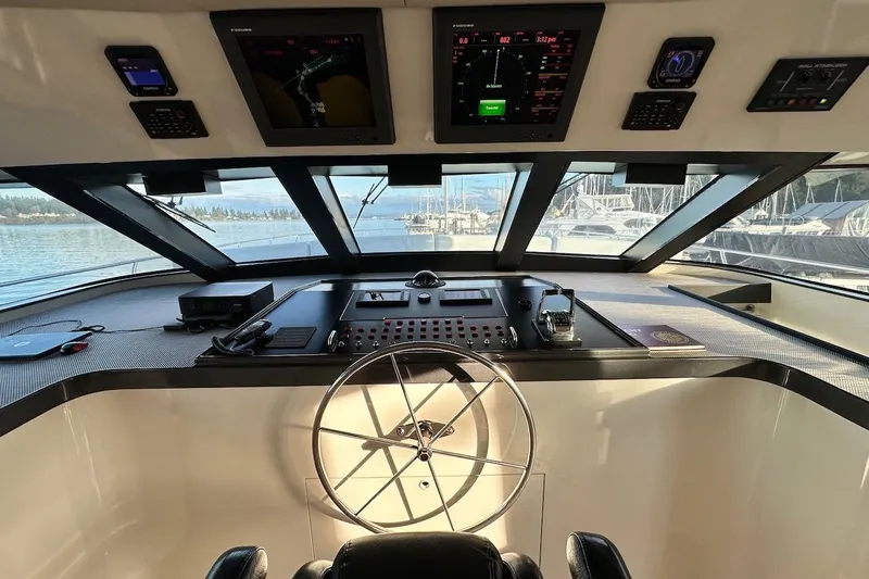 First Home Yacht Photos Pics Cockpit of 1988 Cheoy Lee 92 yacht with navigation instruments and steering wheel.