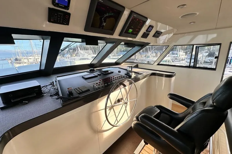 First Home Yacht Photos Pics Interior helm of 1988 Cheoy Lee 92 yacht with modern navigation equipment.