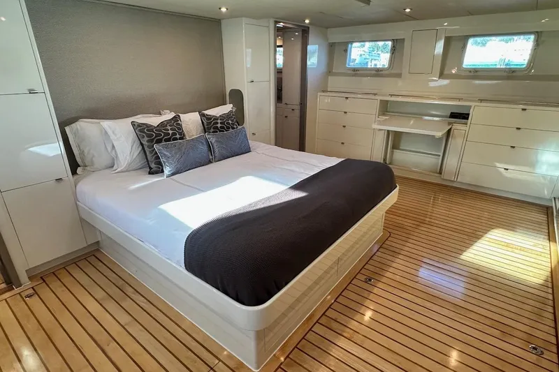 First Home Yacht Photos Pics Luxurious bedroom interior of 1988 Cheoy Lee 92 yacht with elegant wood flooring.
