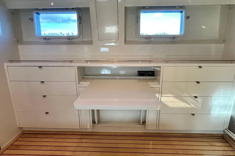 First Home Yacht Photos Pics Luxurious interior of 1988 Cheoy Lee 92 yacht with sleek cabinetry and windows.