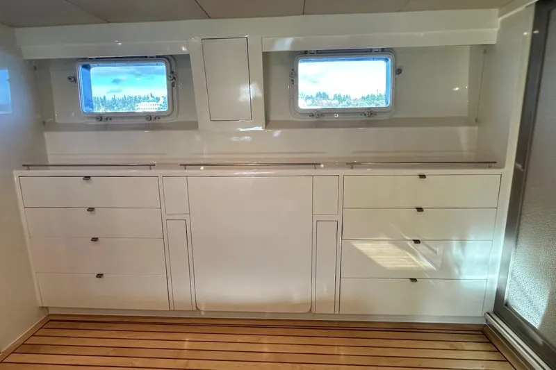 First Home Yacht Photos Pics Interior of 1988 Cheoy Lee 92 yacht with sleek cabinetry and wooden flooring.