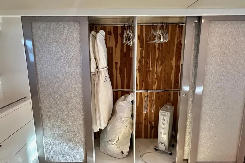 First Home Yacht Photos Pics Closet interior on 1988 Cheoy Lee 92 yacht with robes, hangers, and heater.