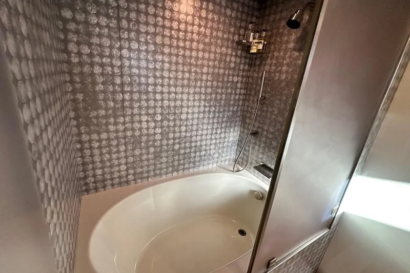 First Home Yacht Photos Pics Luxurious bathroom with modern shower and tub in 1988 Cheoy Lee 92 yacht.