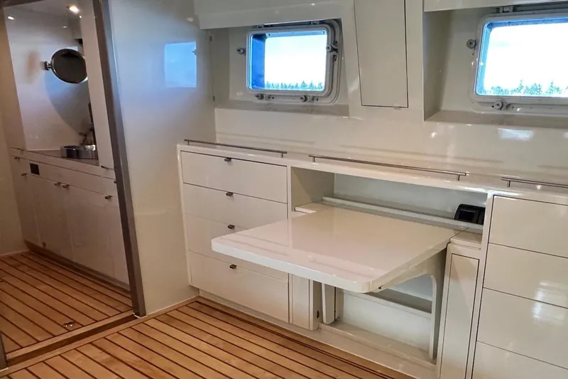 First Home Yacht Photos Pics Interior of 1988 Cheoy Lee 92 yacht with sleek cabinetry and wooden flooring.
