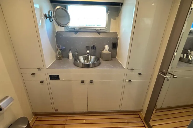 First Home Yacht Photos Pics Luxurious bathroom interior of 1988 Cheoy Lee 92 yacht with modern sink and cabinetry.