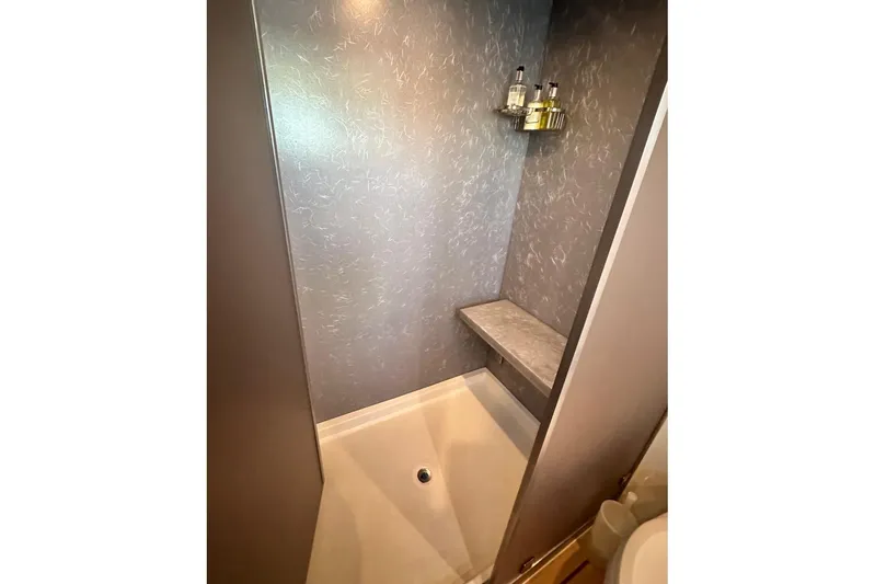 First Home Yacht Photos Pics Shower area in 1988 Cheoy Lee 92 yacht with modern fixtures and seating.